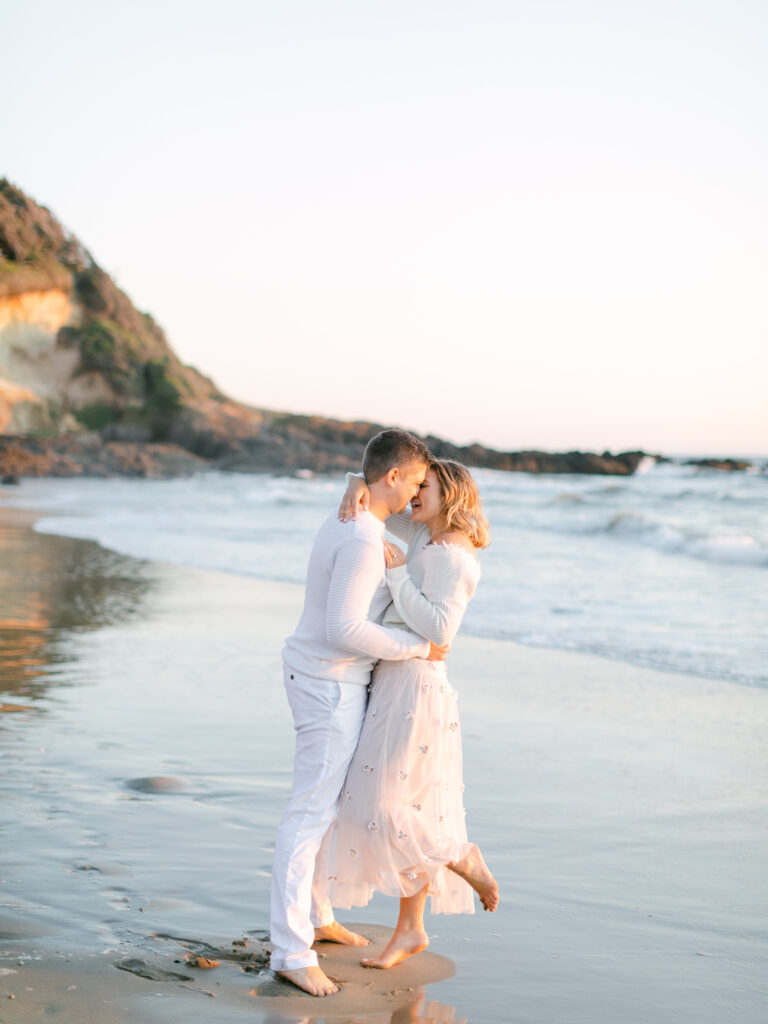 a couple at the coast for their engagement photo session