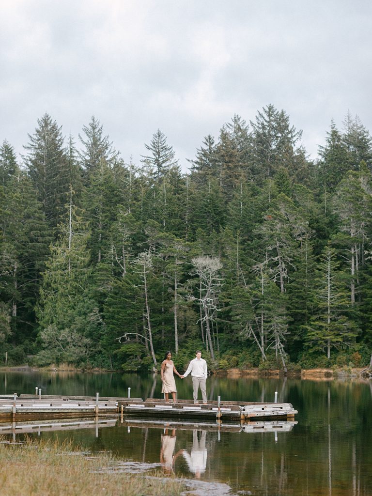 Engaged couple on a dock in a lake