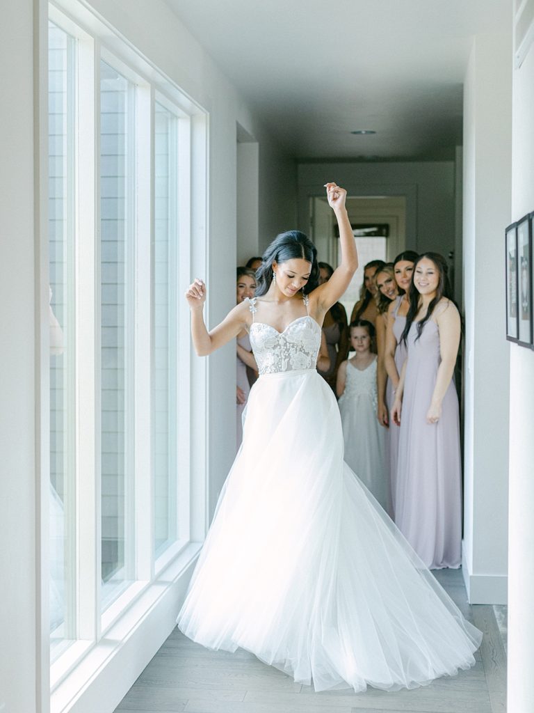 Bride twirling as her bridesmaids watch