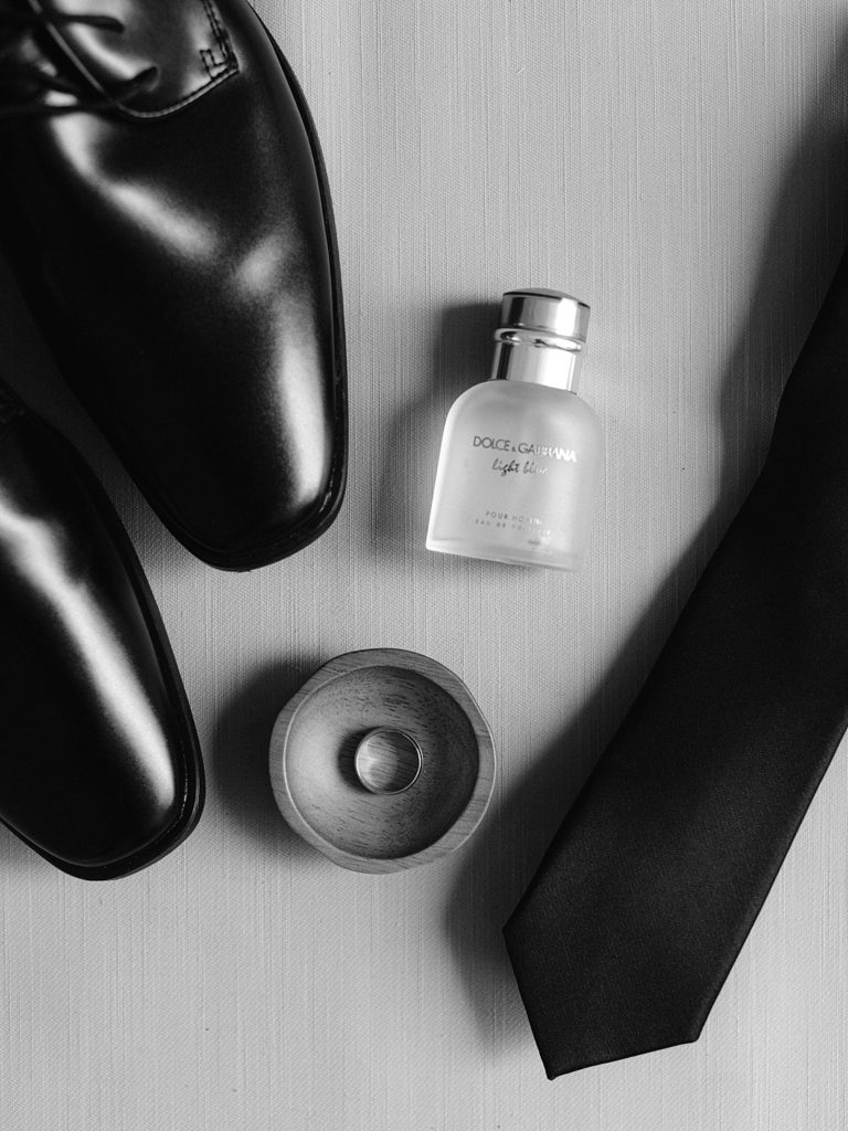 Groom's shoes, cologne, ring, and tie