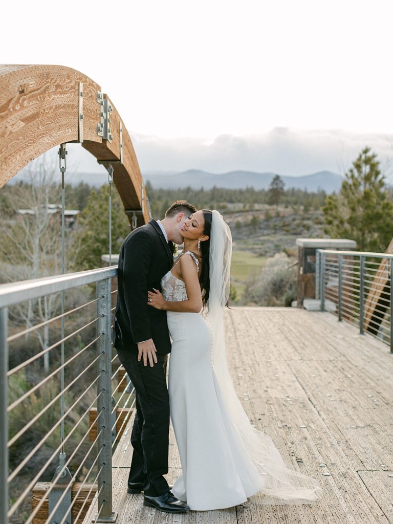 Bride and groom posing on a bridge
