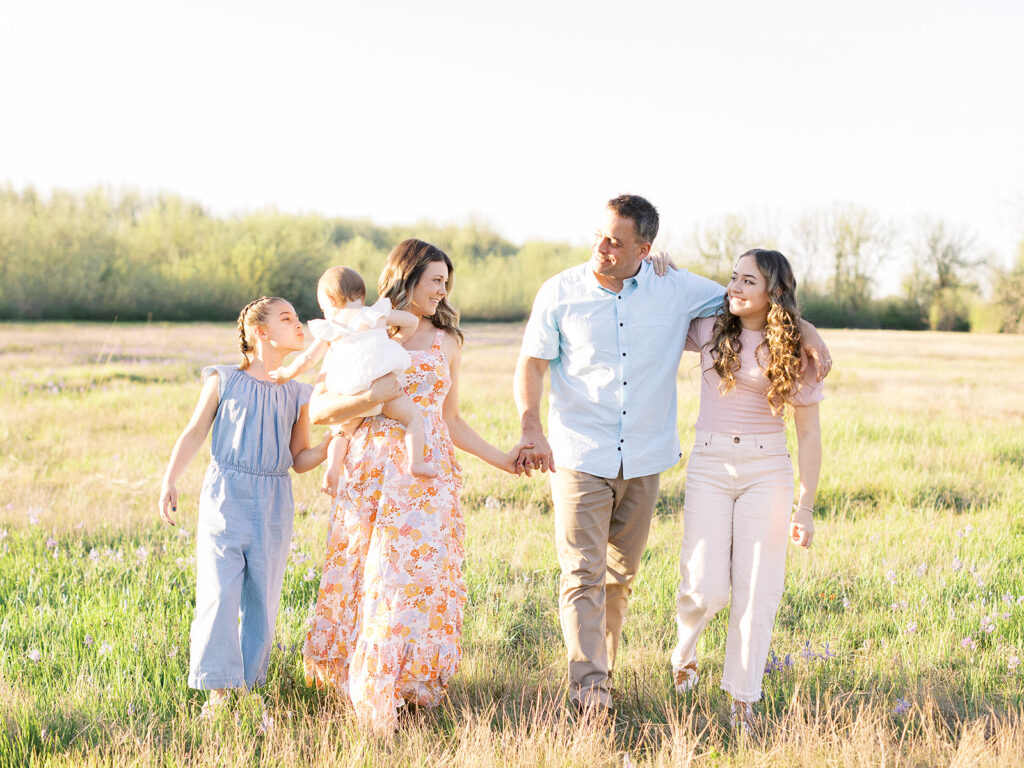 Family wearing coordinating outfits at the park during a spring photo session