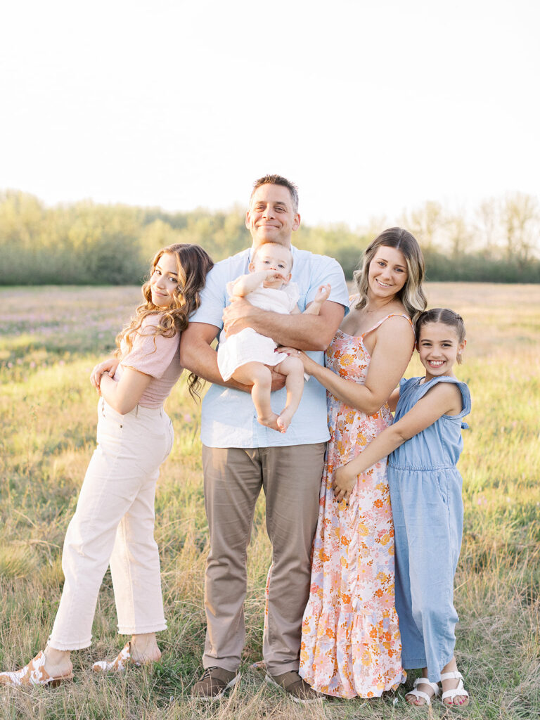 Family wearing coordinating outfits at the park during a spring photo session