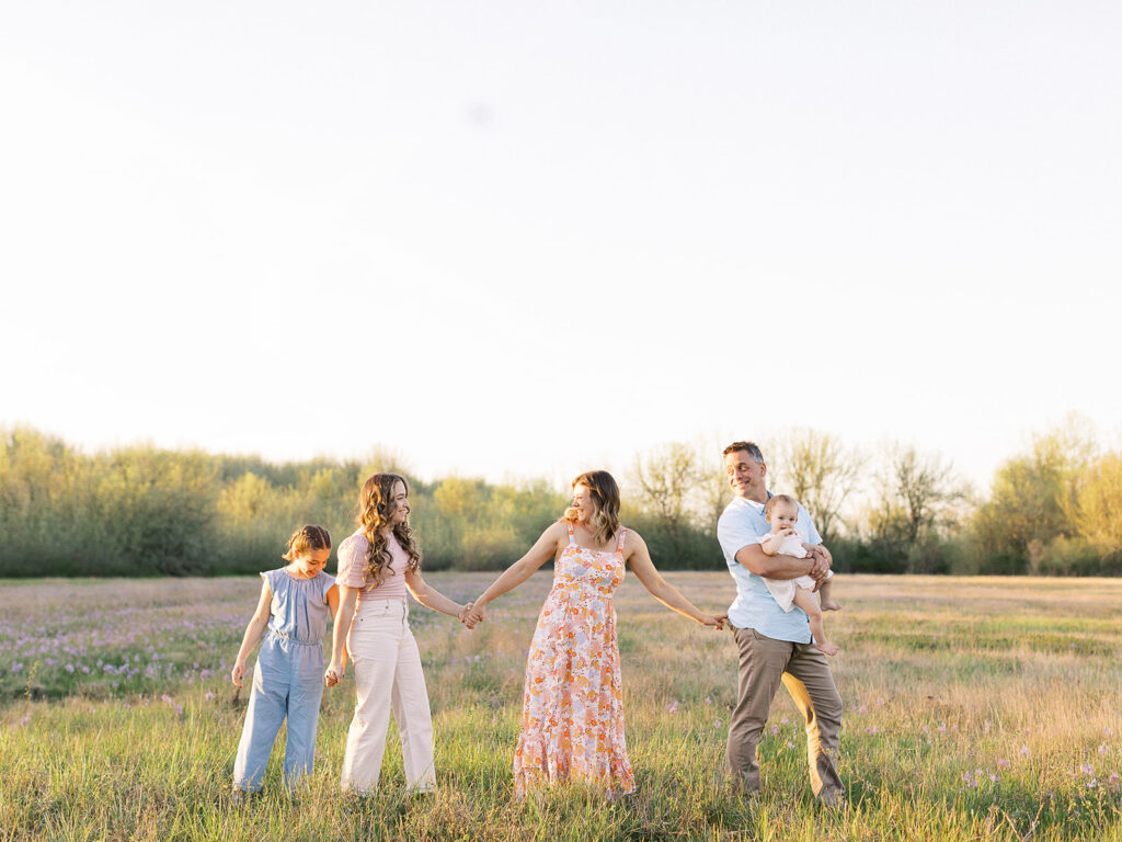 Family wearing coordinating outfits at the park during a spring photo session