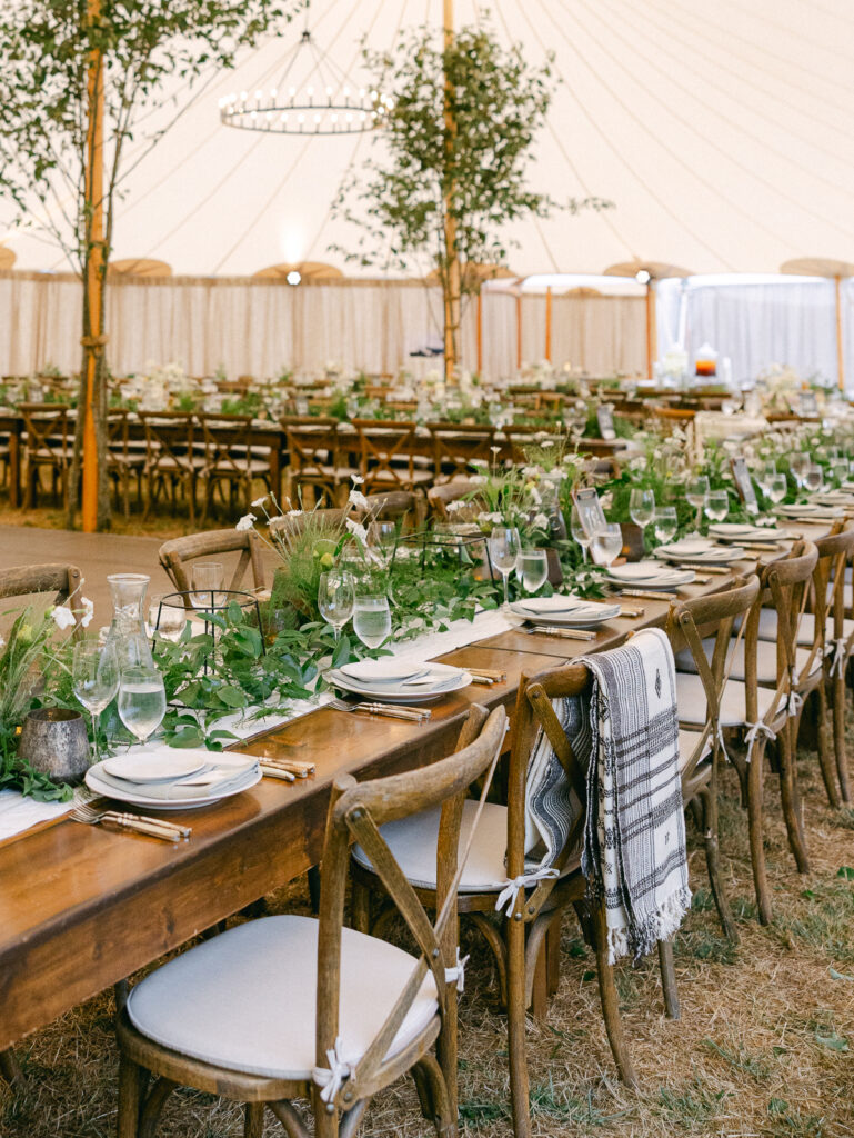 Outdoor private estate wedding reception with long tables and soft lighting