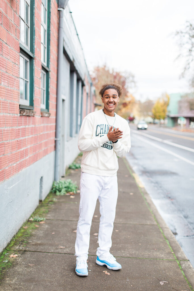 Senior photos in downtown Eugene Oregon with brick backdrop