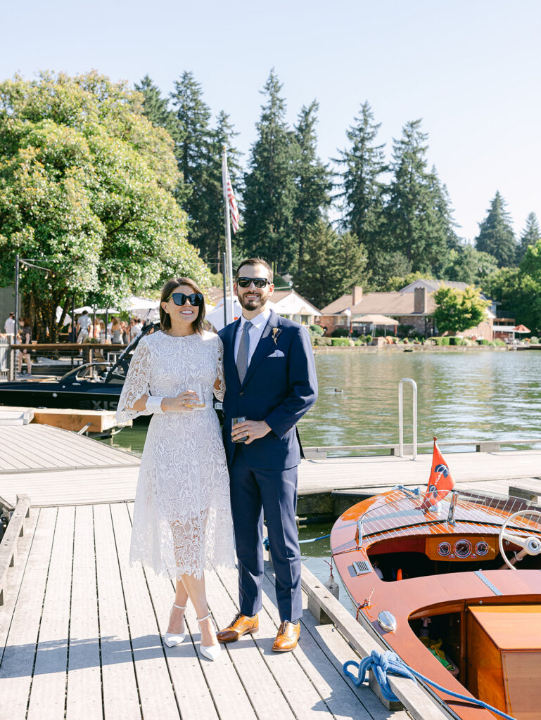 Couple walking along waterfront after wedding ceremony