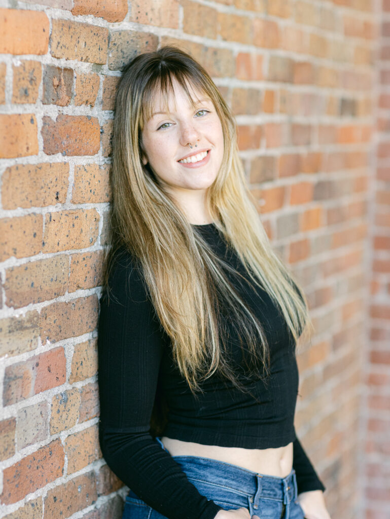 Senior photos in downtown Eugene Oregon with brick backdrop