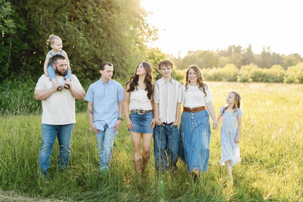 Children running through tall grass during outdoor family photos in Eugene Oregon